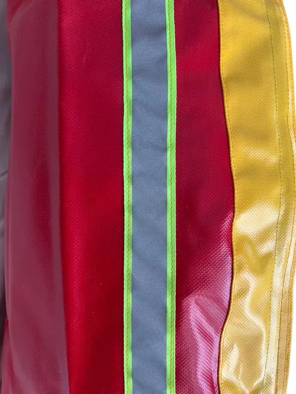 Red, yellow, and gray striped fabric of Standard BlitzFire™ Firefighting Nozzle Cover weather nozzle cover