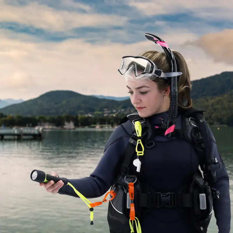 Scuba diver with gear using a glove clip safety holder for secure accessory attachment