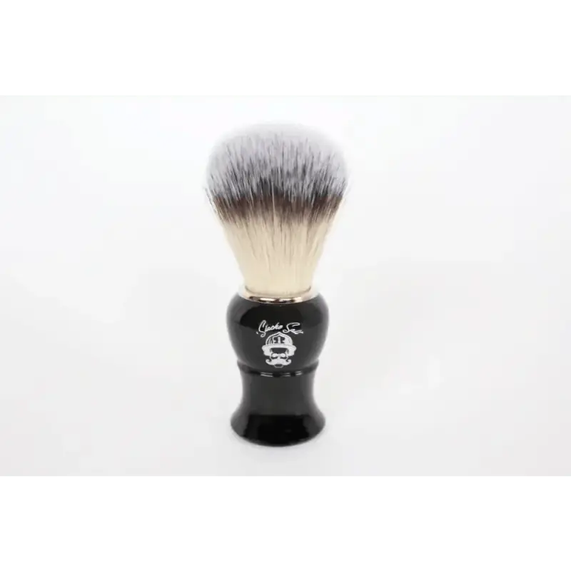 Black-handled shaving brush with white synthetic bristles in Shave Pack for first responders