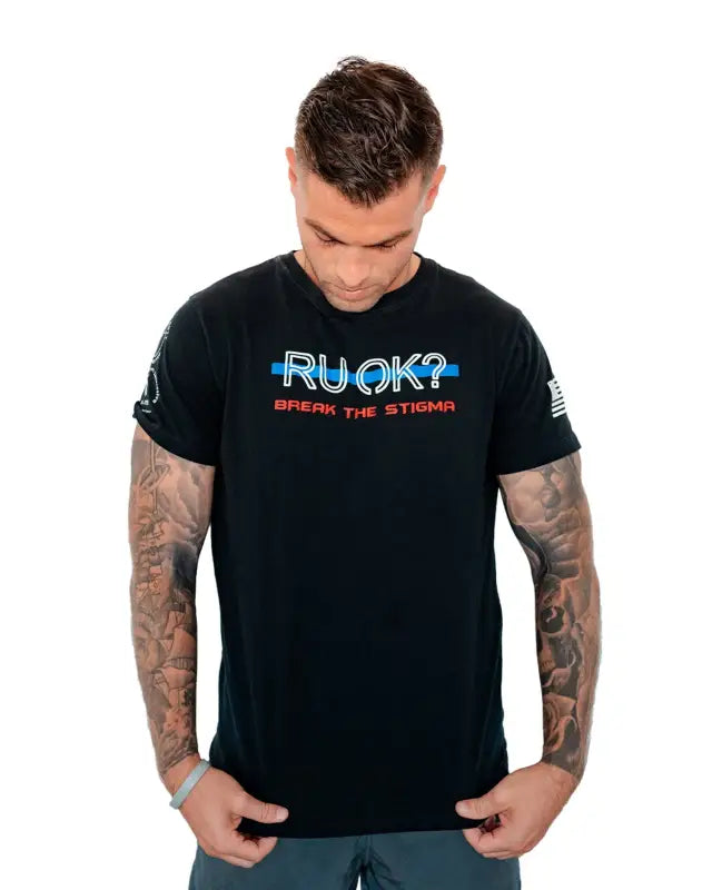 Black Stigma-Breaking Unisex Tee with RUCK text design and tattooed arms showcased