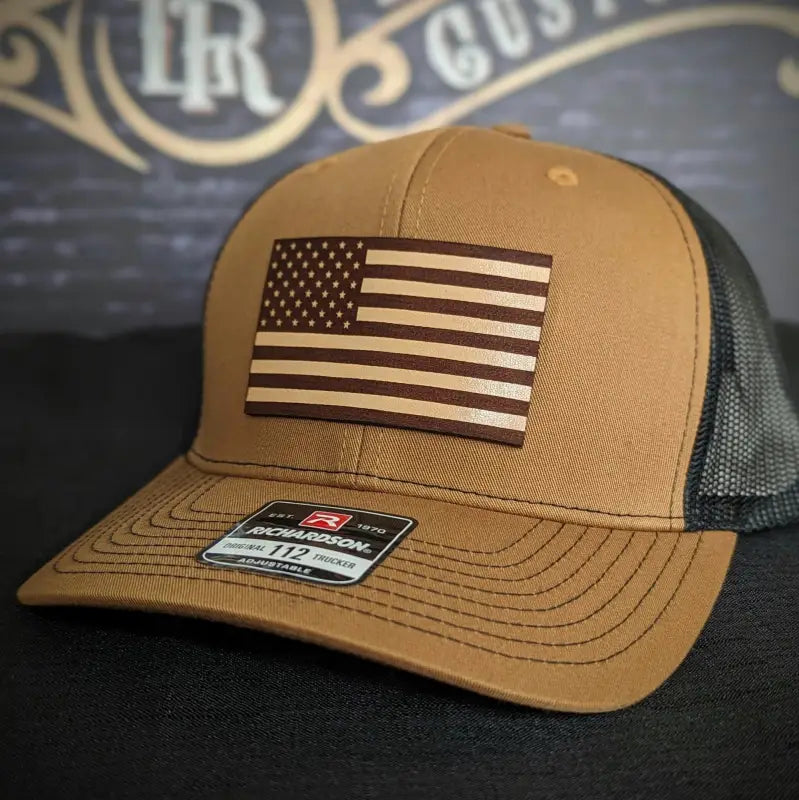Tan and black baseball cap with American flag patch and leather patch for various head sizes