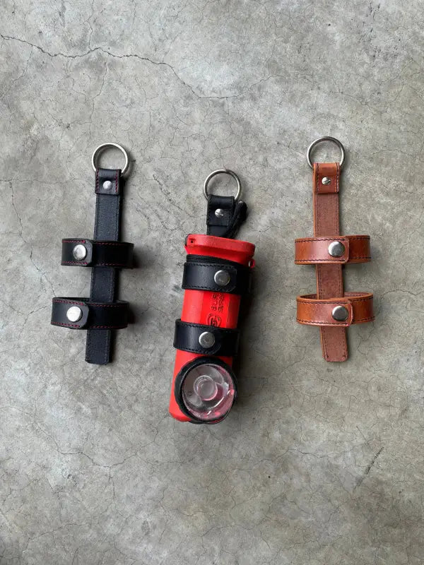 Three leather flashlight holders designed for inverted firefighter flashlights and firefighter flashlight holder use