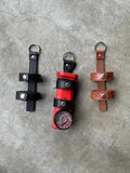 Three leather flashlight holders designed for inverted firefighter flashlights and firefighter flashlight holder use