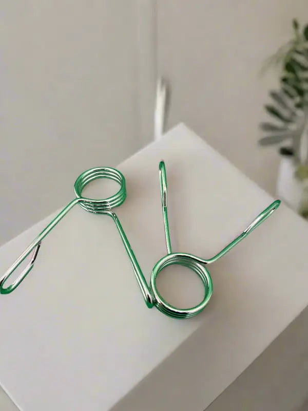 Two green spring clamps from SFE 2’’ Spring Collars, essential for first responders