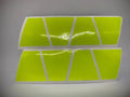 Two rows of retro fluorescent yellow reflective strips on a helmet accessory
