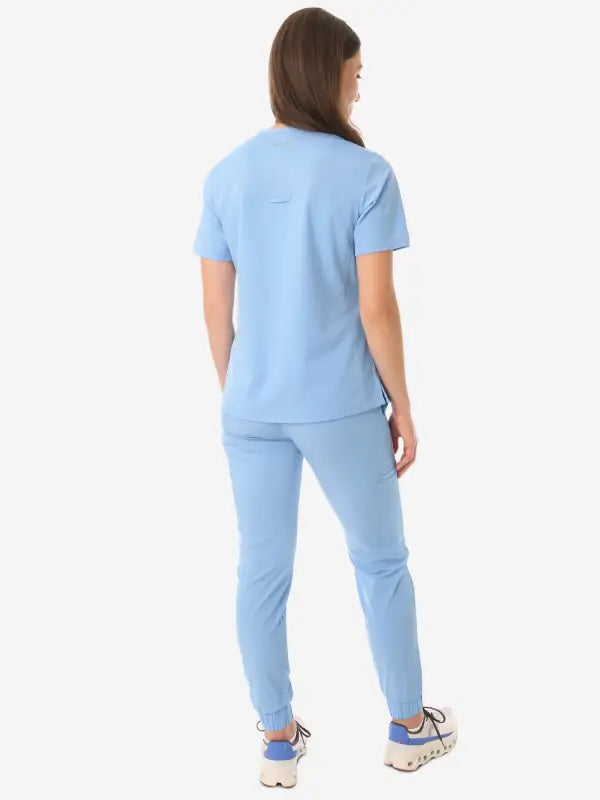 Light blue women’s four-pocket scrub top with matching pants for medical professionals