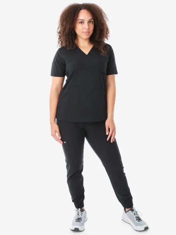 Black women’s four-pocket scrub uniform with v-neck top and jogger-style pants
