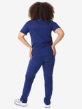 Navy blue women’s four-pocket scrub uniform with white sneakers for healthcare professionals