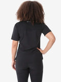 Black women’s four-pocket scrub set with short-sleeved top and fitted pants shown from behind