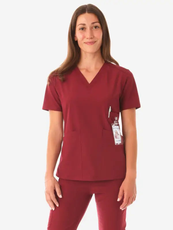 Burgundy women’s four-pocket scrub uniform with v-neck top and matching pants