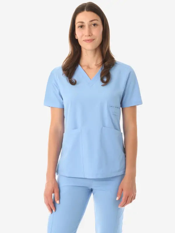 Light blue women’s four-pocket scrub uniform with v-neck top and matching pants