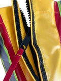 Yellow and red vinyl firefighting nozzle cover with black zipper for weather nozzle protection