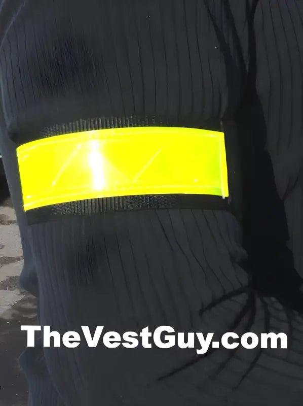 Yellow reflective strip on black fabric of a 1.5 inch reflective armband with velcro closure