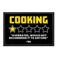 Black removable patch with yellow COOKING text and a one star rating sarcastic review