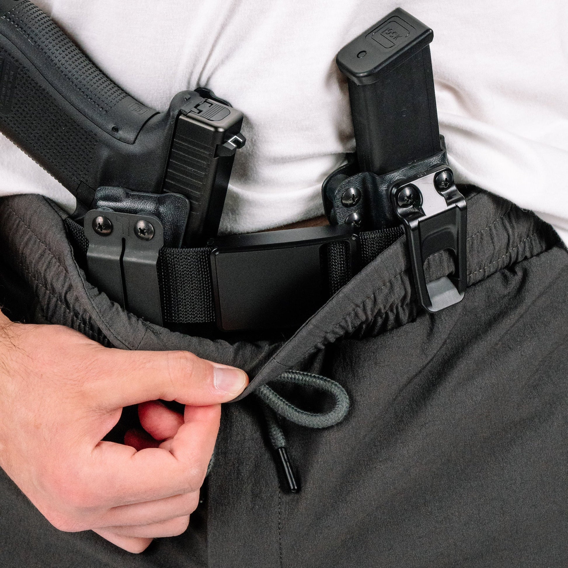 Model wearing Enhanced Rapid Clasp Retention Belt, showcasing its support for concealed carry.