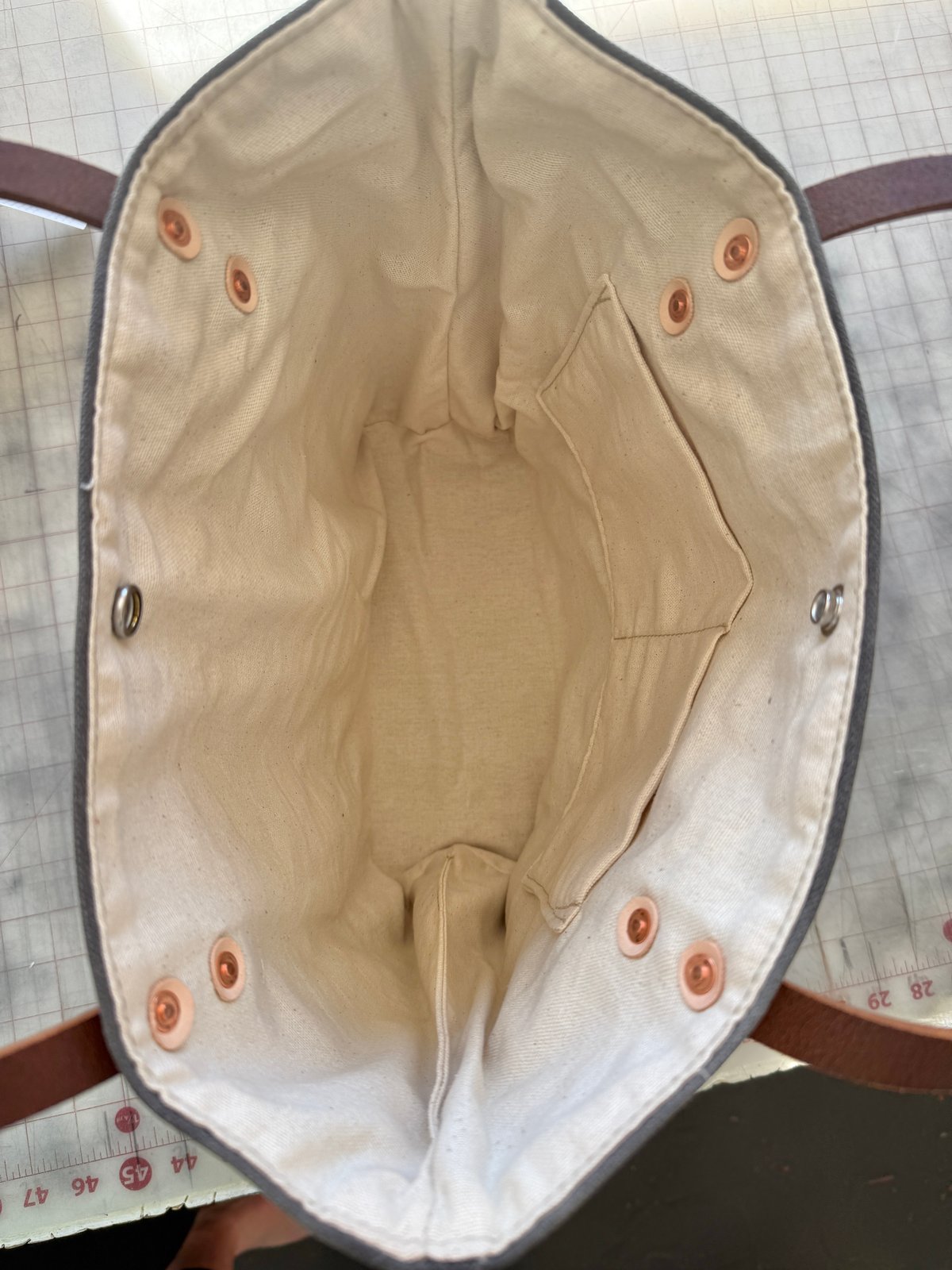 Close-up of the durable water buffalo leather straps on the Olive Green Classic Burn Bag, emphasizing style and practicality in classic burn bags.