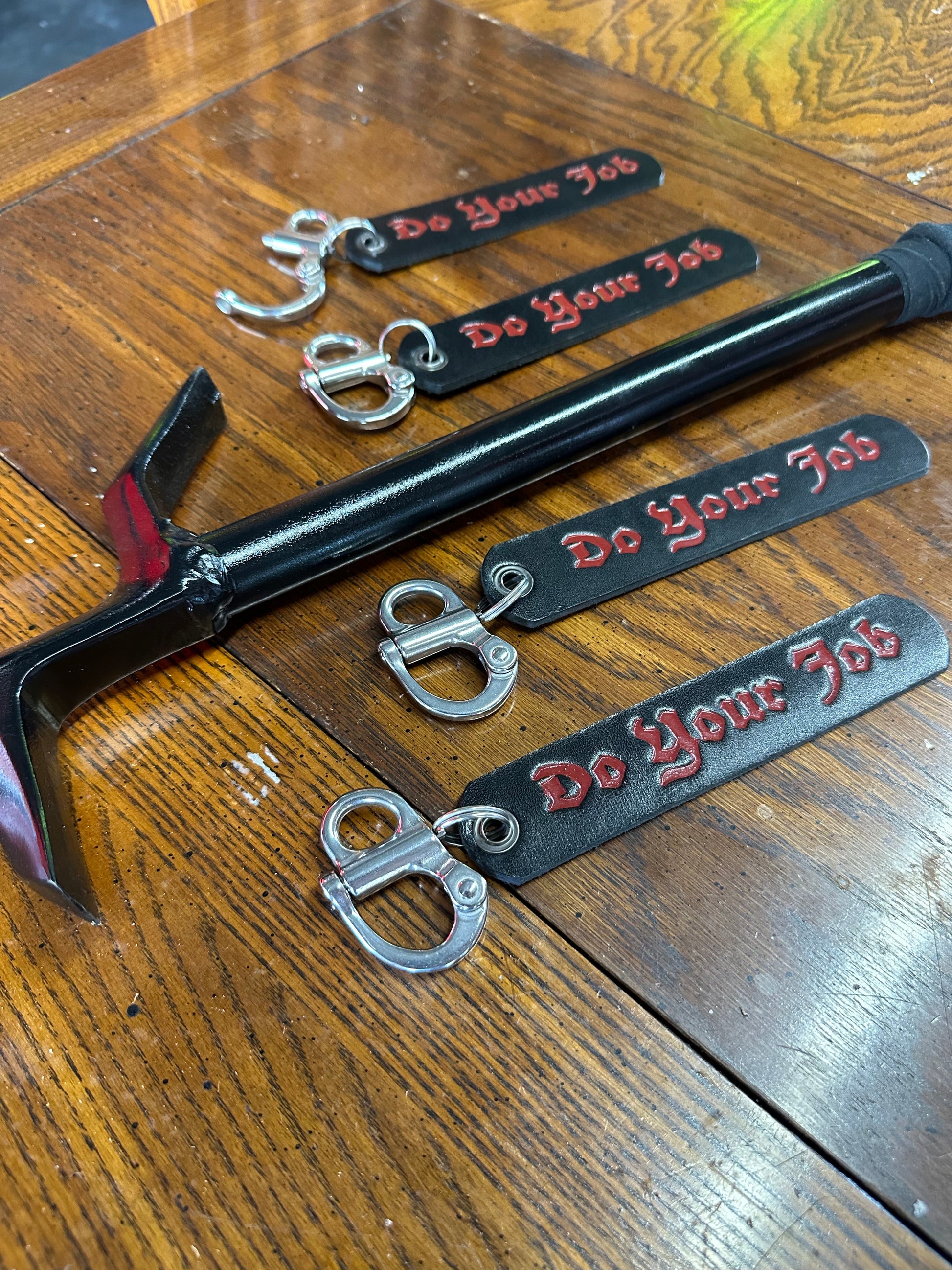 Product display of the DO YOUR JOB SCBA quick release clip, showcasing its essential role in securing SCBA gear for firefighting emergencies.