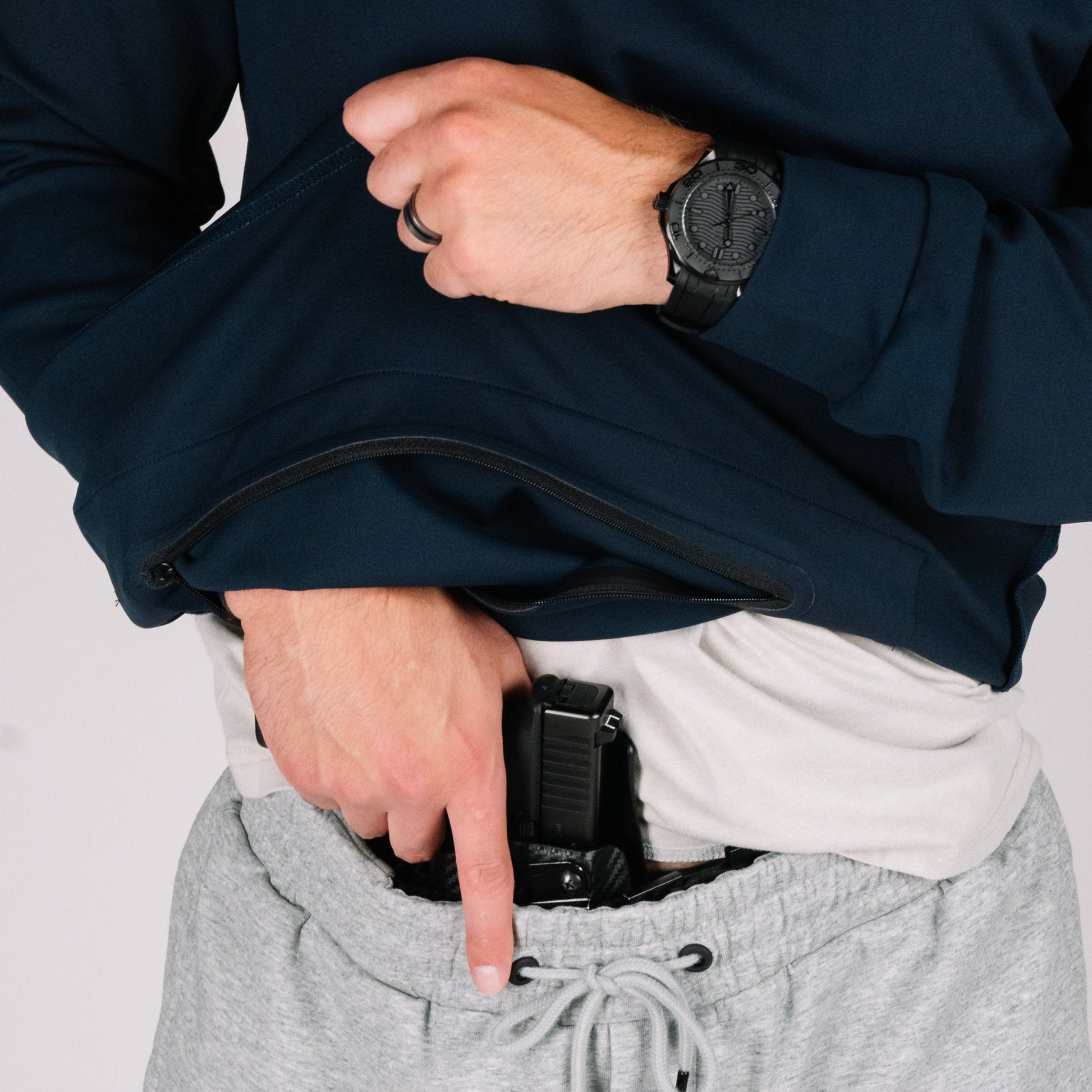 Close-up of the Durable Quarter Zip's Pass Through Pocket, ideal for concealed carry apparel.