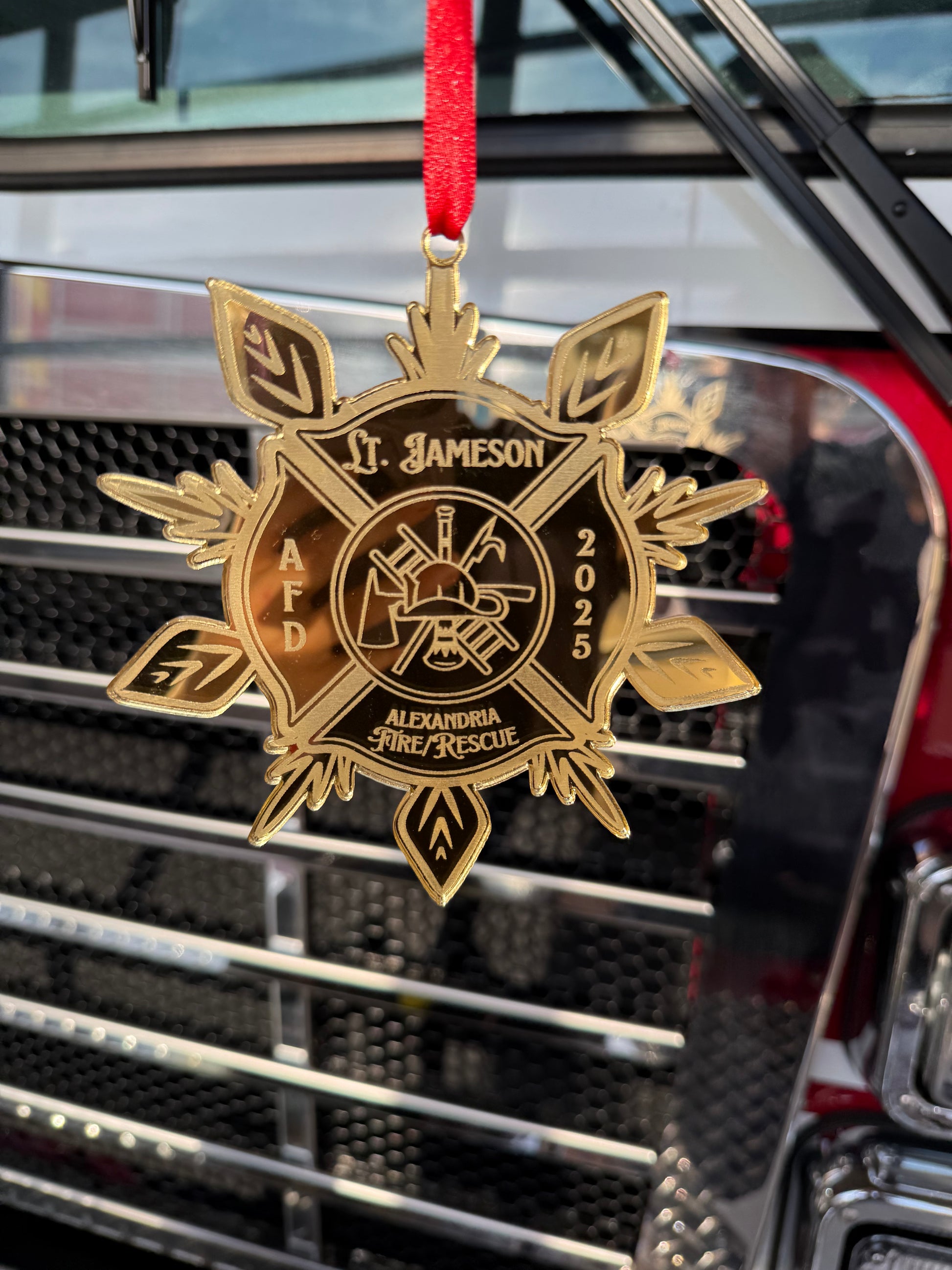 Fire Department Ornament hanging on a Christmas tree, adding a festive touch with firehouse flair.