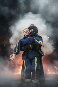Person wearing a blue and yellow safety suit with a helmet on a white background