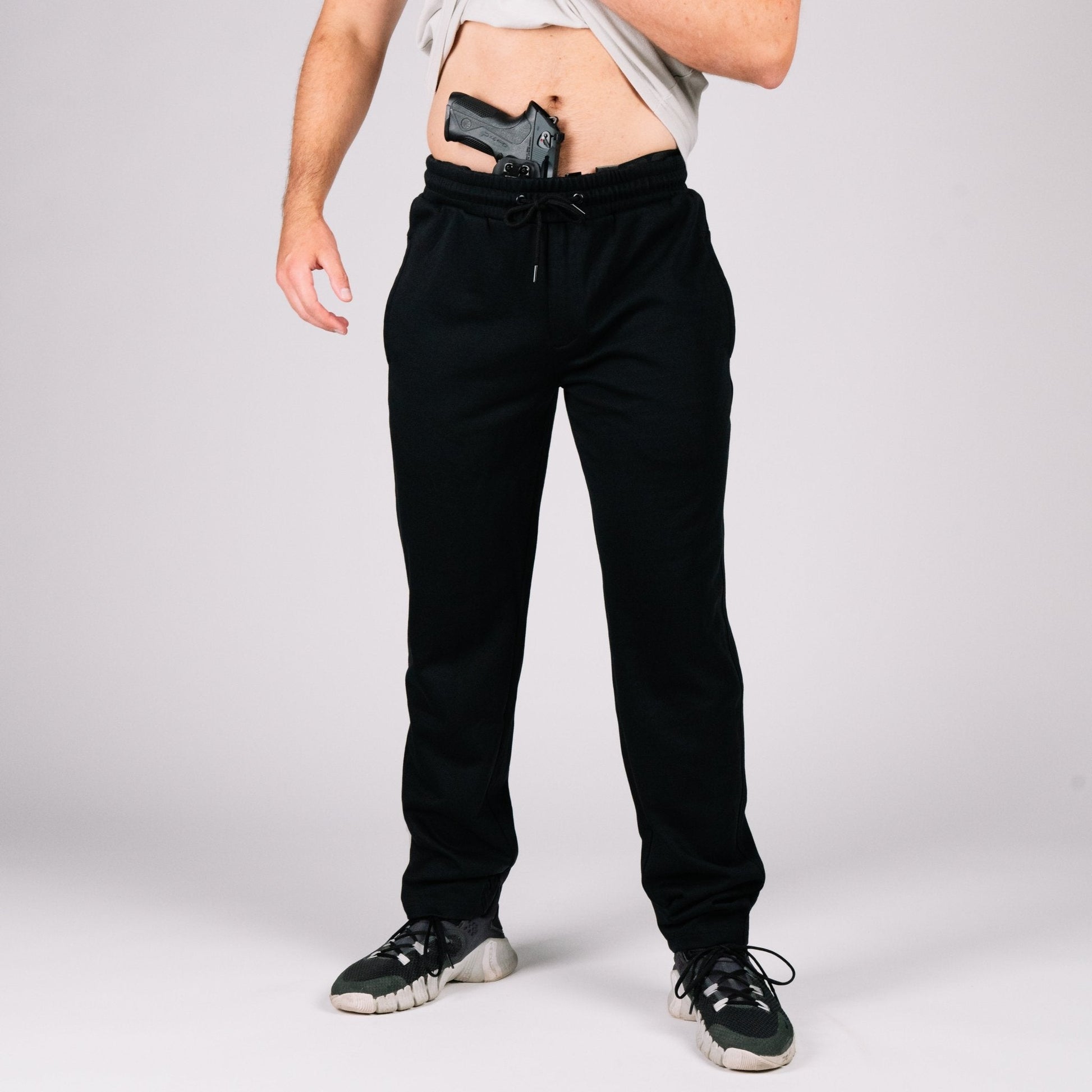 Pairing of Carrier Sweatpants Mk.II in gray with running shoes, perfect for wearing concealed carry sweatpants.