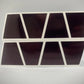 Abstract geometric wall shelf with pink reflective helmet compartments and white borders