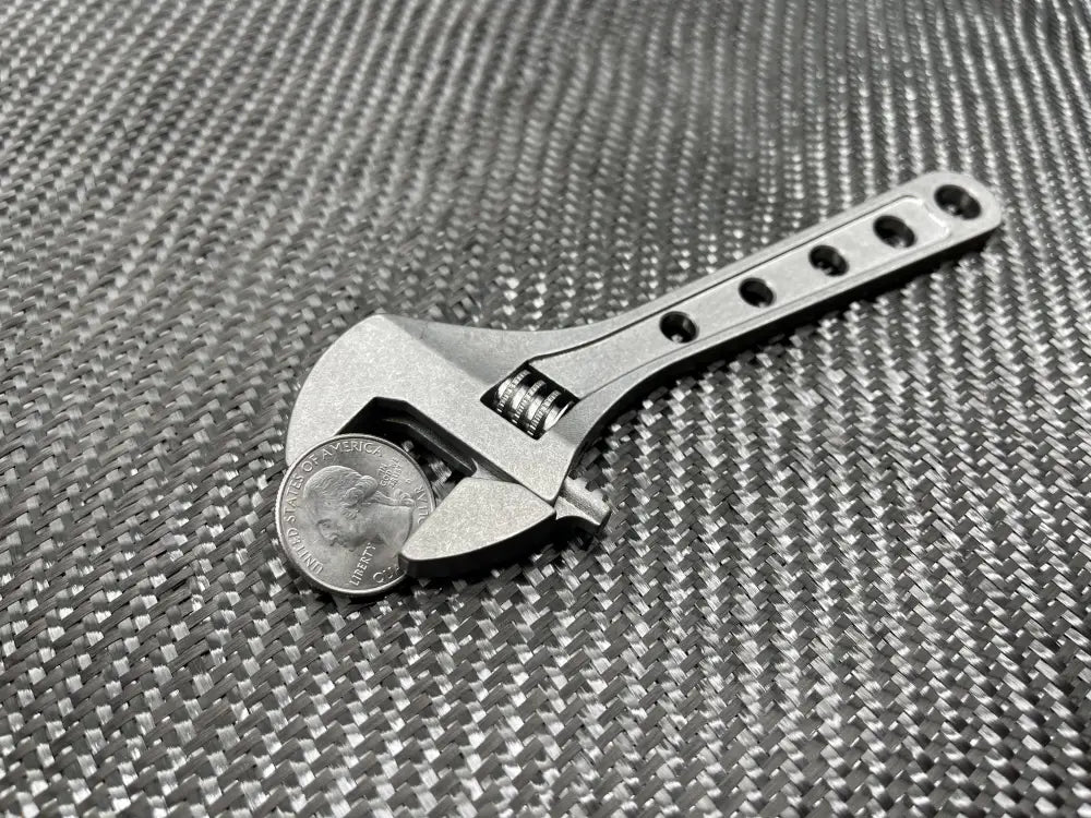 Adjustable Wrench - Titanium 6 Inch with coin in jaws, NSN Pending tool for versatility