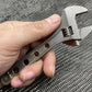 Adjustable Wrench in hand, showcasing the NSN Pending Titanium 6 Inch Wrench