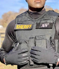 Law enforcement officer in tactical vest and black gloves featuring smart-touch fingertips