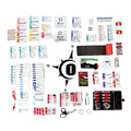 First aid kit contents in a compass rose pattern featuring rolled gauze and elastic patch bandages