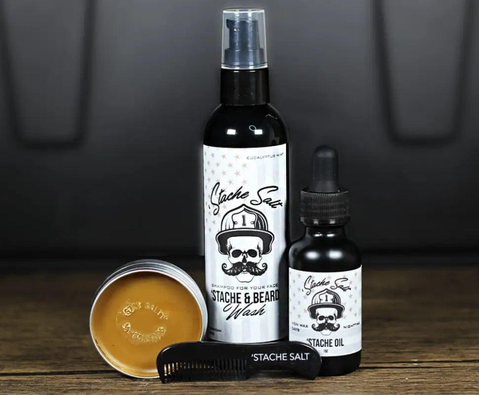 Beard care product set with All Natural Stache Wash, oil, balm, brush, and skull logo