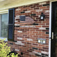 Distressed American Battle Flag on a brick wall showcasing red silver blue colors