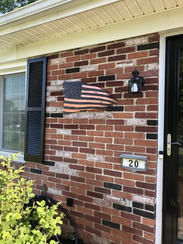 Distressed American Battle Flag on a brick wall showcasing red silver blue colors