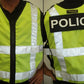 High visibility adjustable vest in fluorescent green with reflective stripes and POLICE text