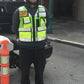 Security guard in ANSI II Cert High Visibility Vest made of fluorescent green mesh