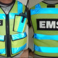 High visibility radio vest with reflective blue stripes and black lettering, ANSI II certified