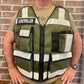 Olive green ODOT Incident Command Vest with reflective stripes over tan shirt