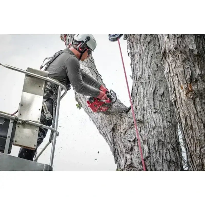 Arborist using Milwaukee M18 Fuel handle chainsaw with chainsaw cutting tree limb