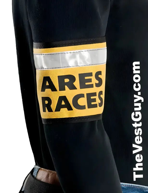 Reflective yellow and silver ARES RACES armband on a black sleeve for races