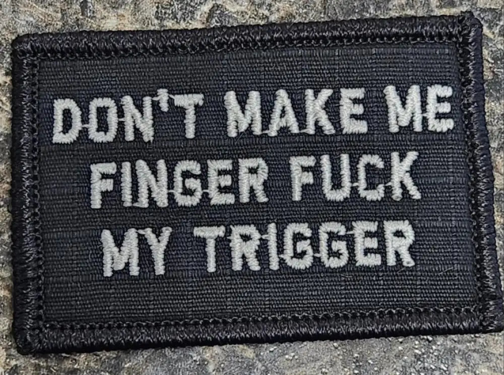 Black tactical morale patch with gray text, trigger - 2x3 design, black w silver