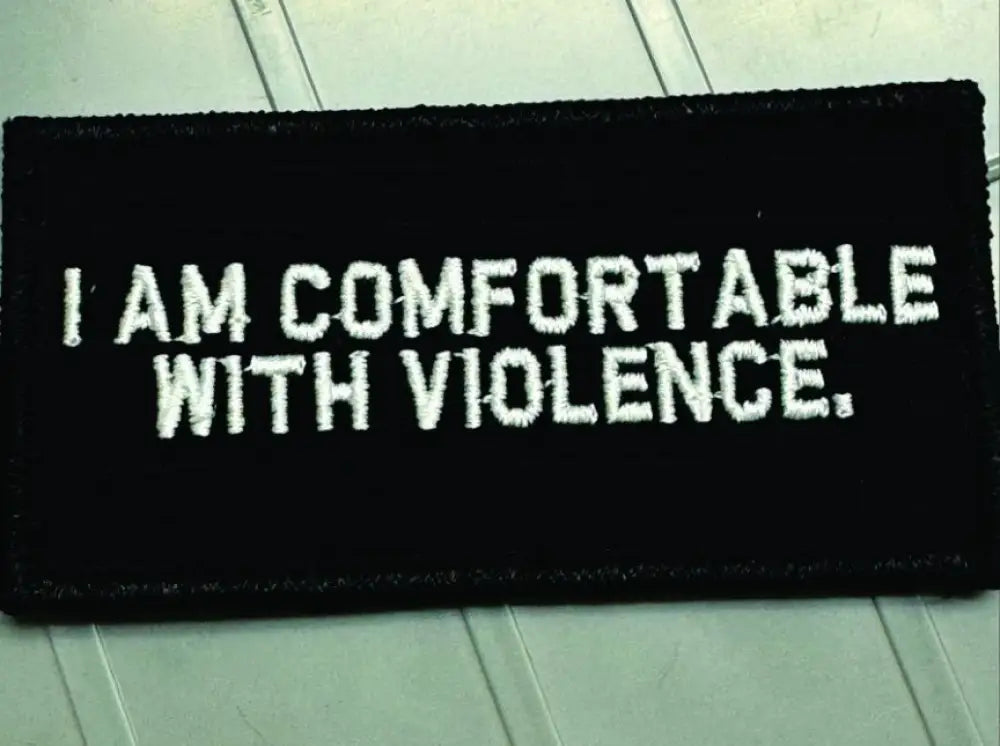 Black w white 2x4 patch with text I AM COMFORTABLE WITH VIOLENCE for edgy style