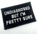 Black patch with white text Undiagnosed But I’m Pretty Sure on olive drab 2x3 patch
