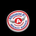 Circular red, white, and blue Asshole Merit Badge helmet decal with wings design