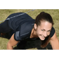 Athlete in black fitted performance shirt smiling during plank exercise