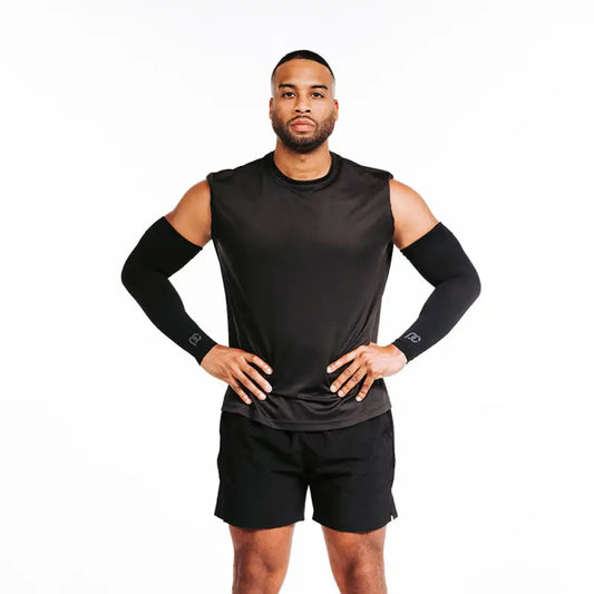 Athletic man in black compression shirt showcasing Arm Sleeves and arm cuffs