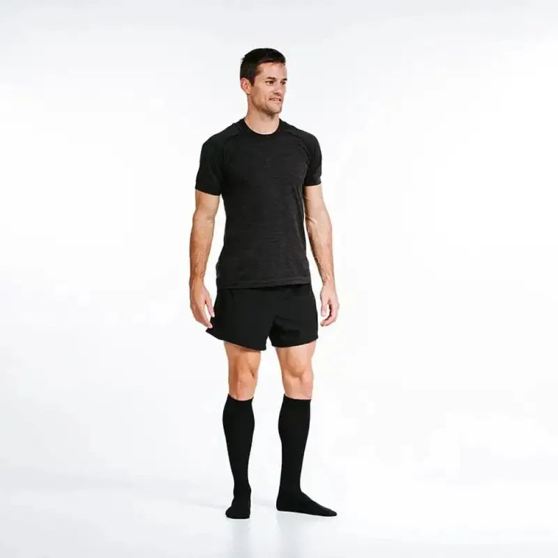 Athletic model in black workout attire showcasing Marathon Black on Black socks