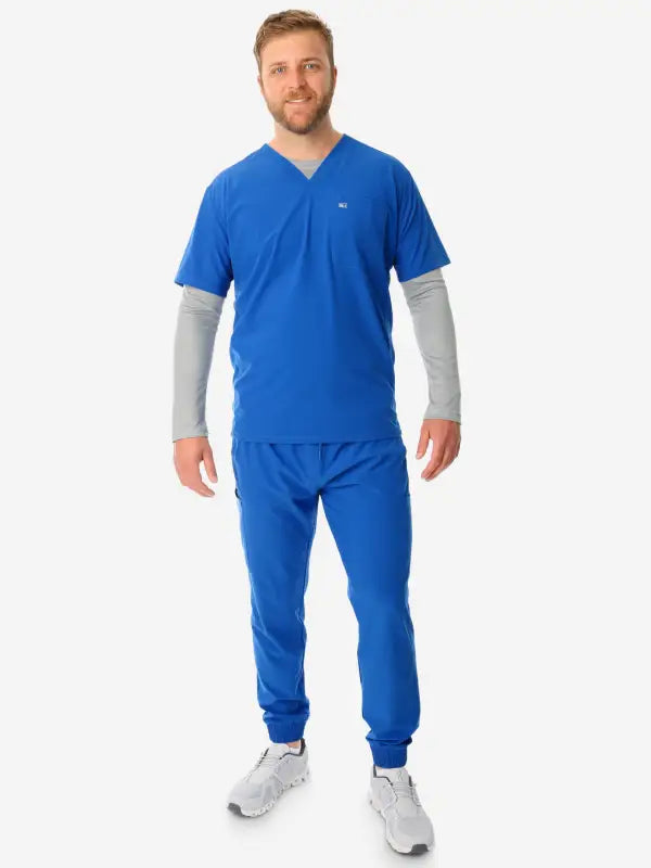 Bright blue men’s long-sleeve underscrub with gray sleeves and matching jogger pants