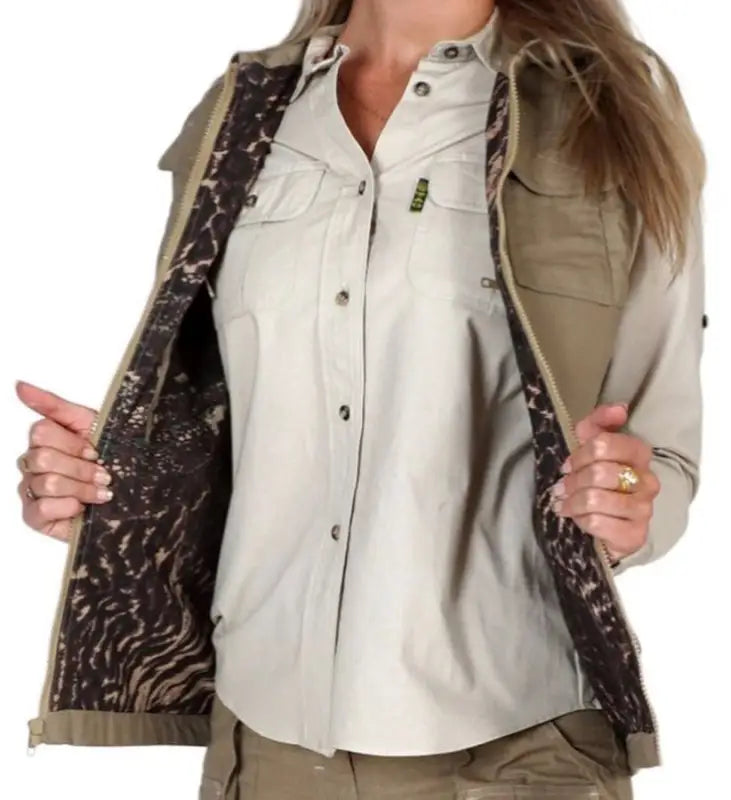 Beige button-up shirt with chest pockets and dark patterned vest lining for safari vest