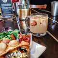 Creamy coffee drink in BenShot Coffee Mug garnished with chocolate candy