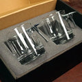 Set of twisted whiskey rocks glasses with solid metal Maltese Cross in foam packaging